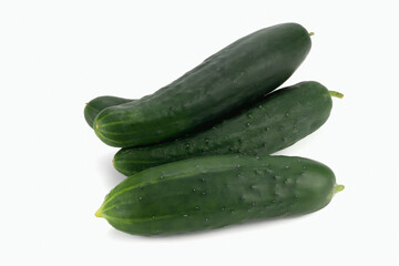 A pile of cucumbers isolated on white background. Close up view.