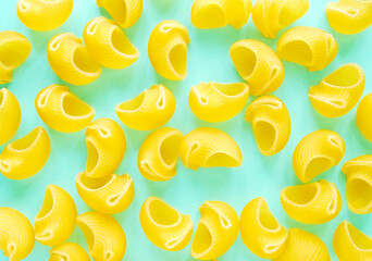 Pasta elbow macaroni on clean blue background, a top view of a group of scattering pasta on blue background