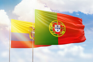 Sunny blue sky and flags of portugal and ecuador