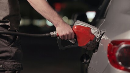 Fuel station nozzle filling car tank