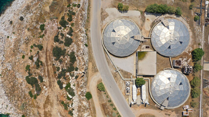Aerial drone top view photo of round waste separators in sewage treatment plant of Psitaleia, Piraeus, Attica, Greece