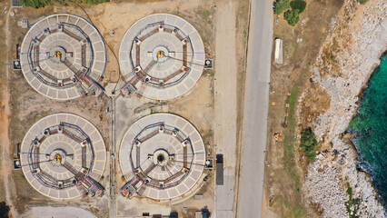 Aerial drone top view photo of round waste separators in sewage treatment plant of Psitaleia, Piraeus, Attica, Greece