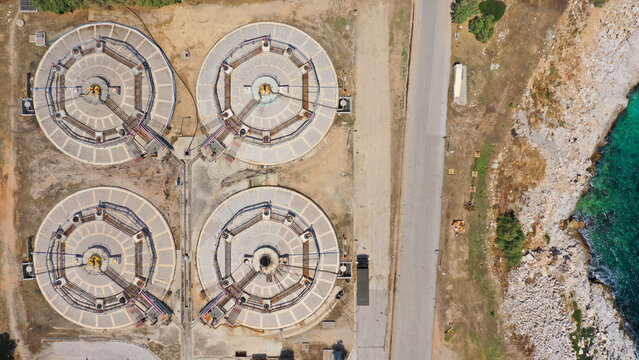 Aerial drone top view photo of round waste separators in sewage treatment plant of Psitaleia, Piraeus, Attica, Greece
