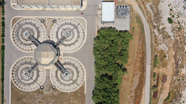 Aerial drone top view photo of round waste separators in sewage treatment plant of Psitaleia, Piraeus, Attica, Greece