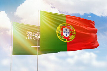 Sunny blue sky and flags of portugal and saudi arabia