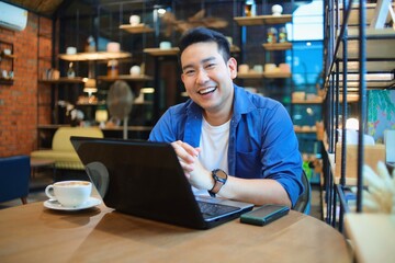person working on laptop in cafe
