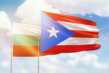 Sunny blue sky and flags of puerto rico and bulgaria