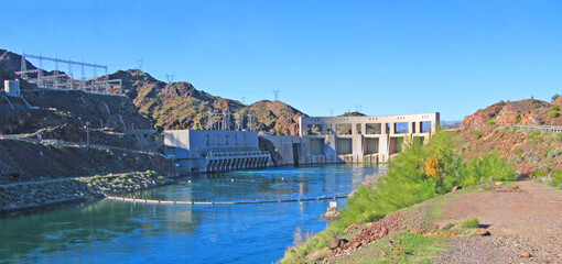 Parker Dam from the Arizona side.  A concrete arch-gravity dam that crosses the Colorado River.  The dam straddles the Arizona-California state border at the narrows the river passes through
