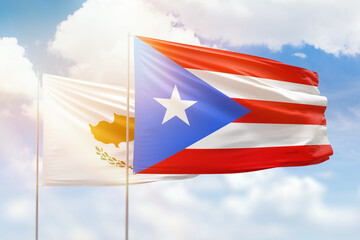 Sunny blue sky and flags of puerto rico and cyprus