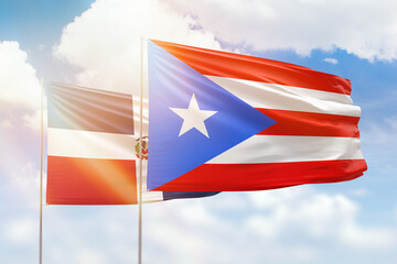 Sunny blue sky and flags of puerto rico and dominican republic