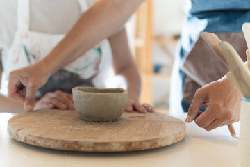 Woman potter teaching ceramic in her art studio