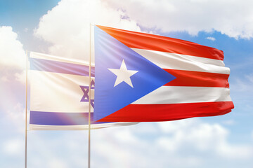 Sunny blue sky and flags of puerto rico and israel