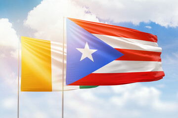 Sunny blue sky and flags of puerto rico and ivory coast