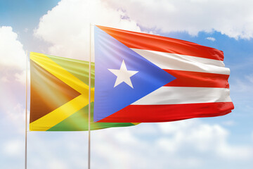 Sunny blue sky and flags of puerto rico and jamaica