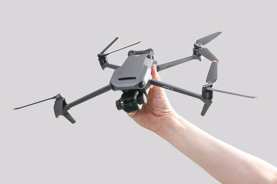 explore consumer drone with unique tele camera scout and plan your shots in hand on gray background