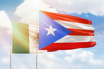 Sunny blue sky and flags of puerto rico and mexico