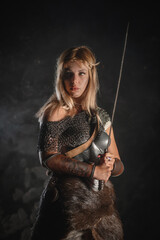 Warrior woman in the armor and with the sword concept.