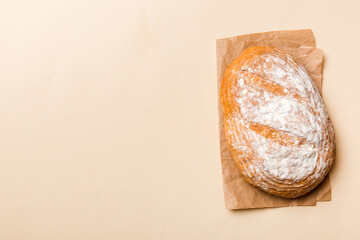 Freshly baked delicious french bread with napkin on rustic table top view. Healthy white bread loaf