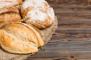 Homemade natural breads. Different kinds of fresh bread as background, perspective view with copy space