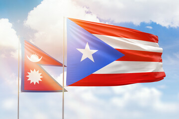 Sunny blue sky and flags of puerto rico and nepal
