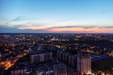 Aerial view on vivid evening cityscape, city residential buildings development in sunset. Kharkiv city center in sunset colors, Ukraine