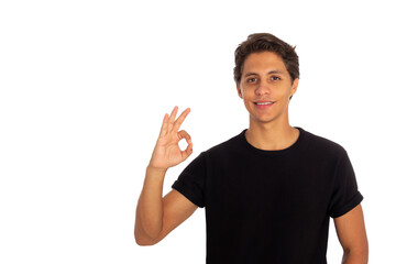 Young man making the ok gesture , he has everything under control , gesture that everything is ok , standing on a white background.