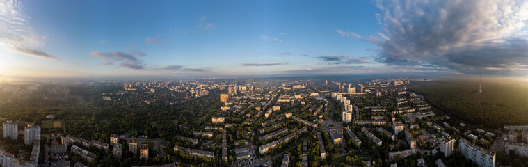 Fototapeta na wymiar Sunny morning cityscape extra wide panorama in city residential district. Aerial colorful view above buildings and streets, Pavlovo Pole, Kharkiv Ukraine