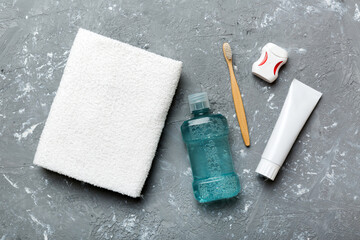 Mouthwash and other oral hygiene products on colored table top view with copy space. Flat lay. Dental hygiene. Oral care products and space for text on light background. concept