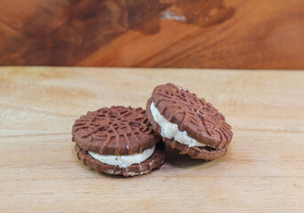 biscuit chocolate with sugar cream on wooden background