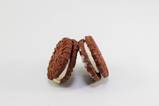 Chocolate biscuits covered with sugar cream, photo on a white background