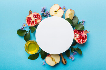 Flat lay composition with Blank flyer poster and symbols jewish Rosh Hashanah holiday attributes on colored background, New Year holiday Traditional. Top view with copy space mock up