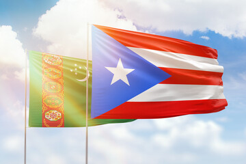 Sunny blue sky and flags of puerto rico and turkmenistan