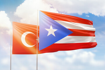 Sunny blue sky and flags of puerto rico and turkey