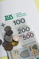 Polish money zlotys PLN, next to it the inscription "ZUS Zakład Ubezpieczeń Społecznych"