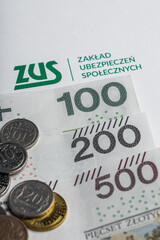 Polish money zlotys PLN, next to it the inscription "ZUS Zakład Ubezpieczeń Społecznych"