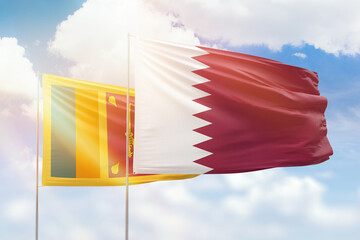 Sunny blue sky and flags of qatar and sri lanka
