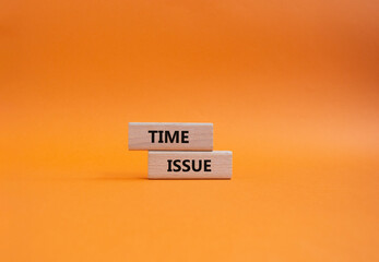 Time issue symbol. Wooden blocks with words Time issue. Beautiful orange background. Business and Time issue concept. Copy space.