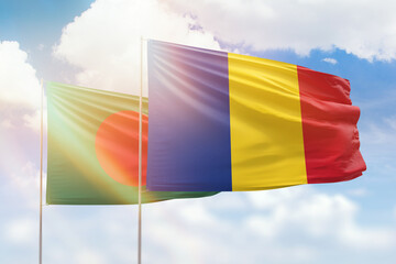 Sunny blue sky and flags of romania and bangladesh