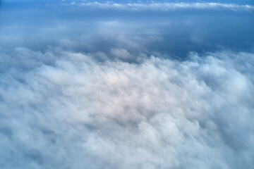 Aerial view from high altitude of earth covered with puffy rainy clouds forming before rainstorm