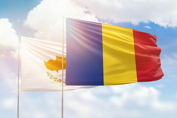 Sunny blue sky and flags of romania and cyprus