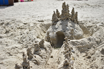 artistic sand castle on the beach at the north sea coast of germany built by children