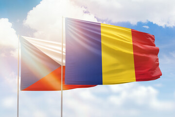 Sunny blue sky and flags of romania and czechia