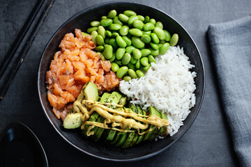 Buddha or poke bowl served on dark