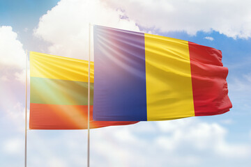 Sunny blue sky and flags of romania and lithuania
