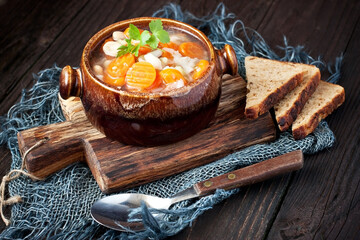 Bowl of delicious vegetables soup on wooden table