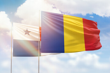 Sunny blue sky and flags of romania and panama