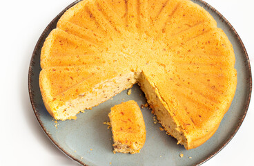 sliced carrot cake on petrol green plate white background
