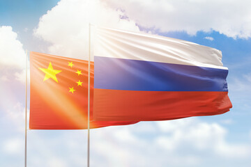 Sunny blue sky and flags of russia and china