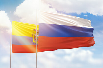 Sunny blue sky and flags of russia and ecuador