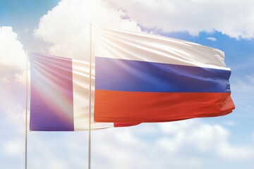 Sunny blue sky and flags of russia and france